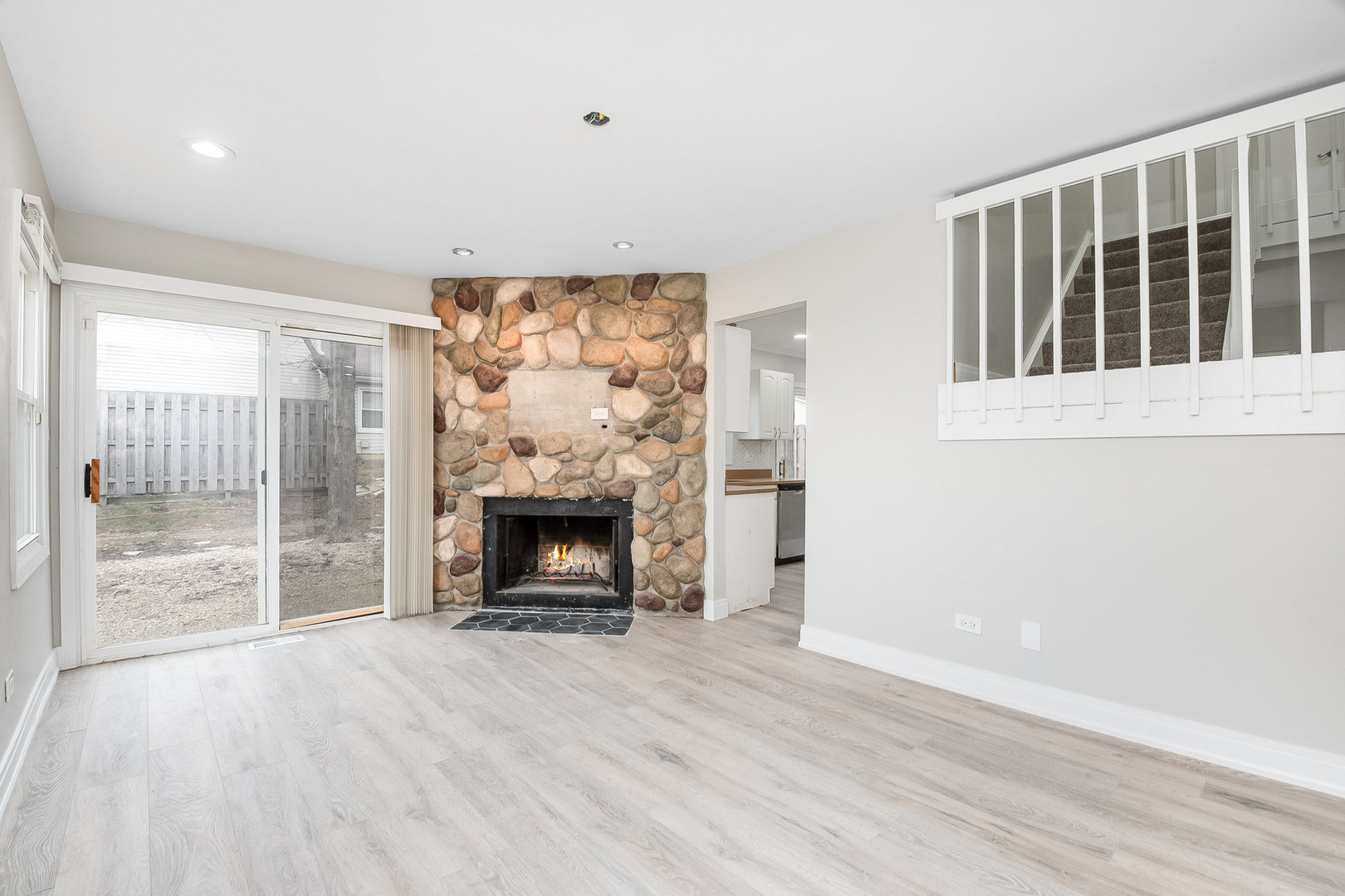 235 Hedgerow Drive Bloomingdale, IL 60108 - Photo 12 of 24 a view of an empty room with wooden floor and a window