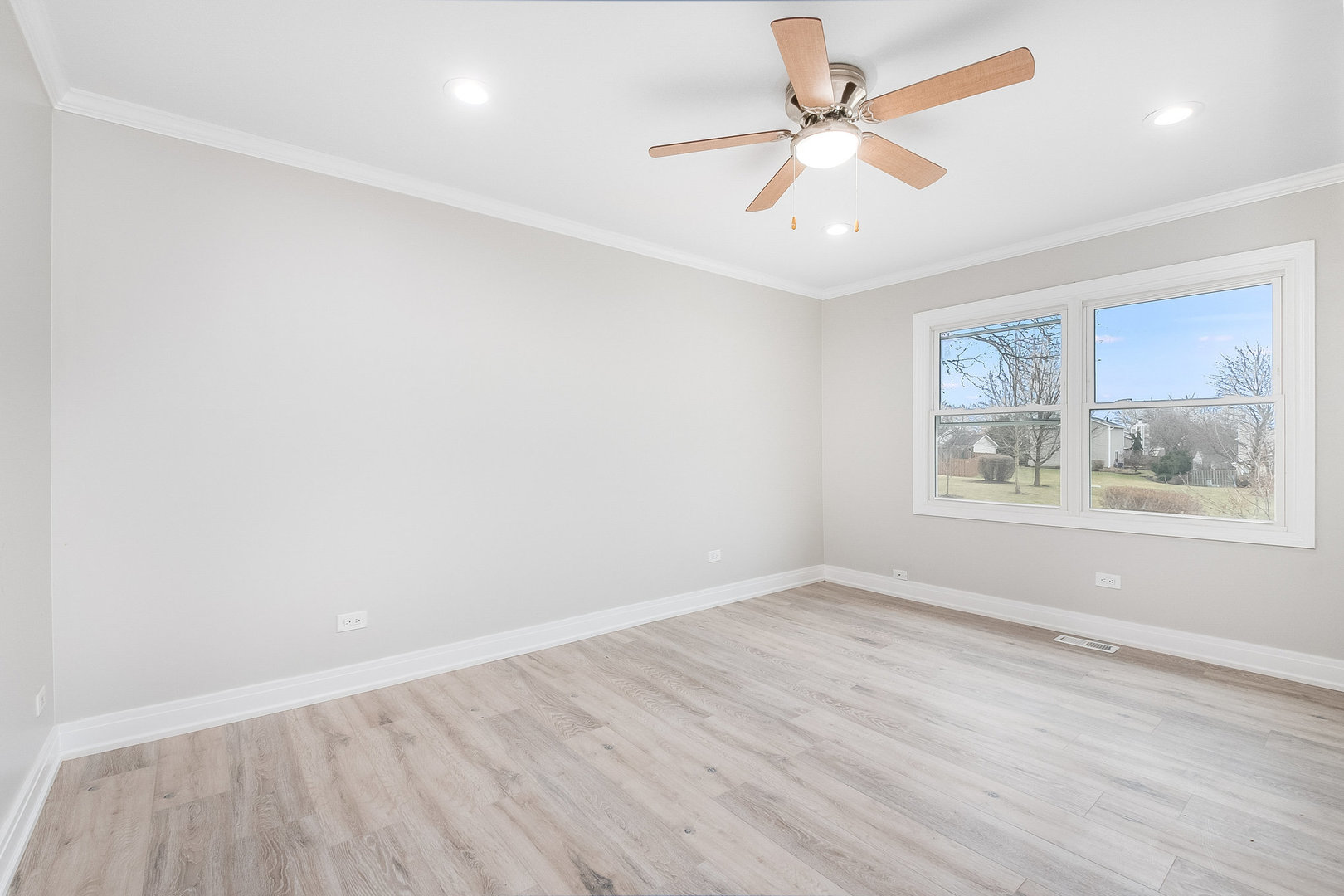 235 Hedgerow Drive Bloomingdale, IL 60108 - Photo 16 of 24 wooden floor in an empty room with a window