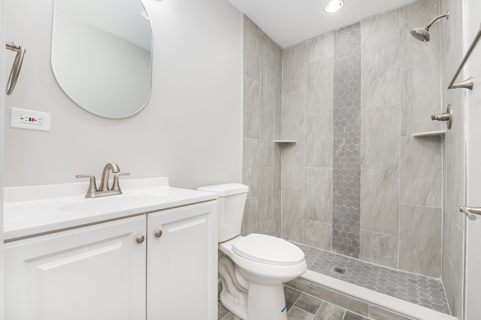 235 Hedgerow Drive Bloomingdale, IL 60108 - Photo 17 of 24 a bathroom with a sink a toilet and shower