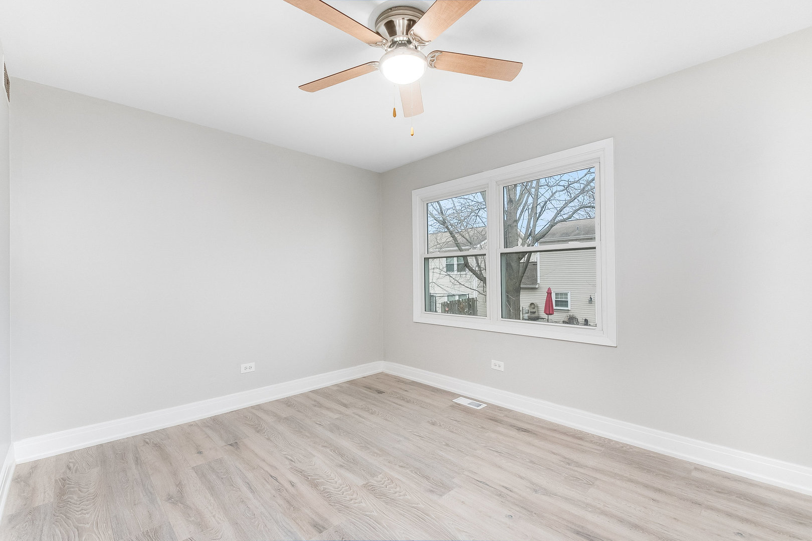 235 Hedgerow Drive Bloomingdale, IL 60108 - Photo 18 of 24 an empty room with a window and a ceiling fan