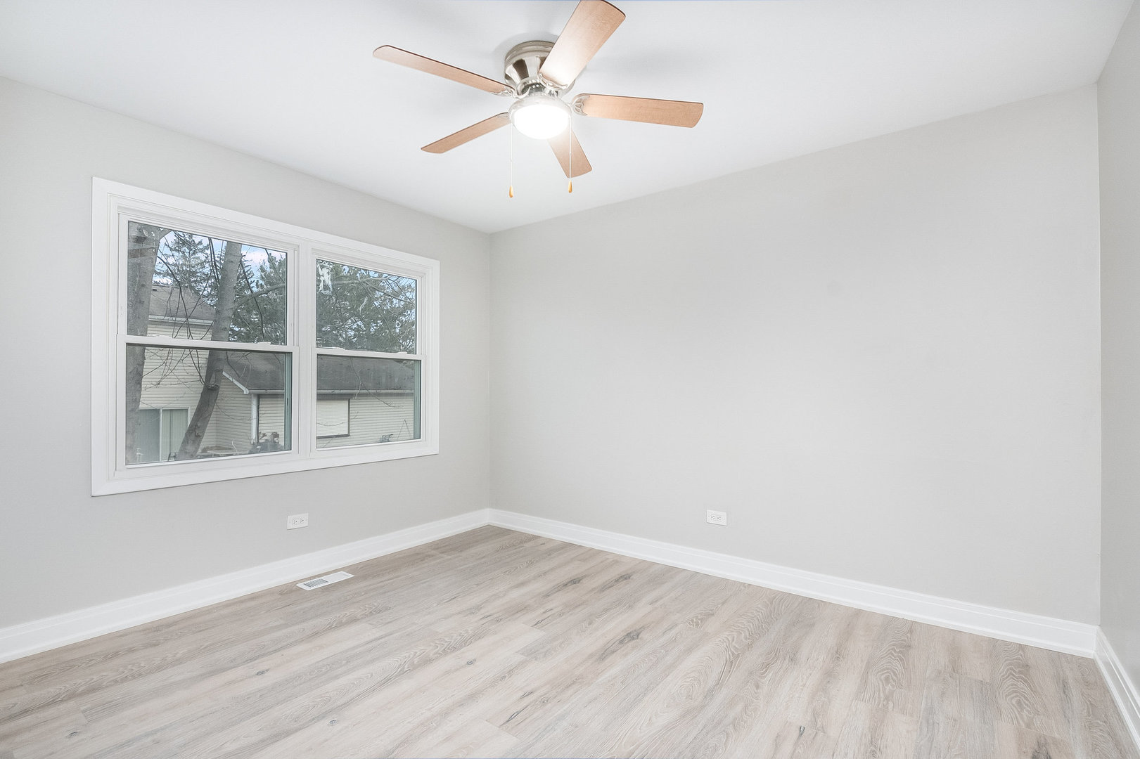 235 Hedgerow Drive Bloomingdale, IL 60108 - Photo 19 of 24 an empty room with wooden floor and windows
