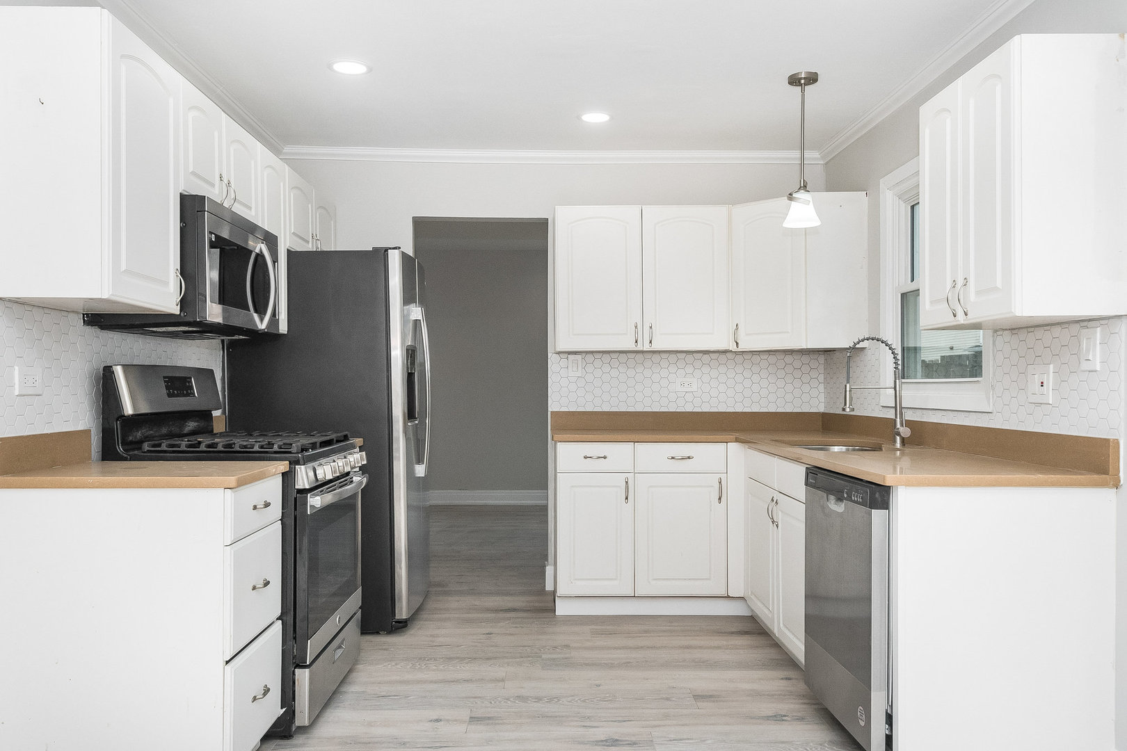 235 Hedgerow Drive Bloomingdale, IL 60108 - Photo 3 of 24 a kitchen with stainless steel appliances granite countertop a sink stove and refrigerator
