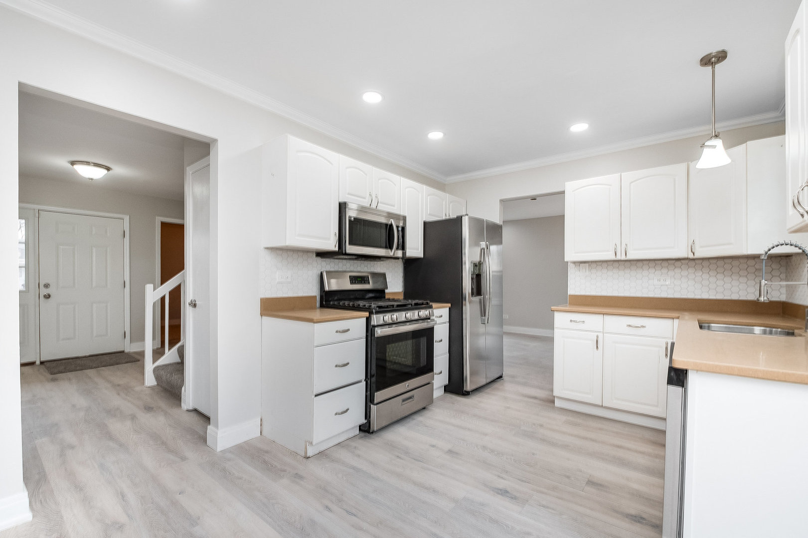 235 Hedgerow Drive Bloomingdale, IL 60108 - Photo 4 of 24 a kitchen with stainless steel appliances granite countertop a refrigerator a stove top oven a sink and dishwasher