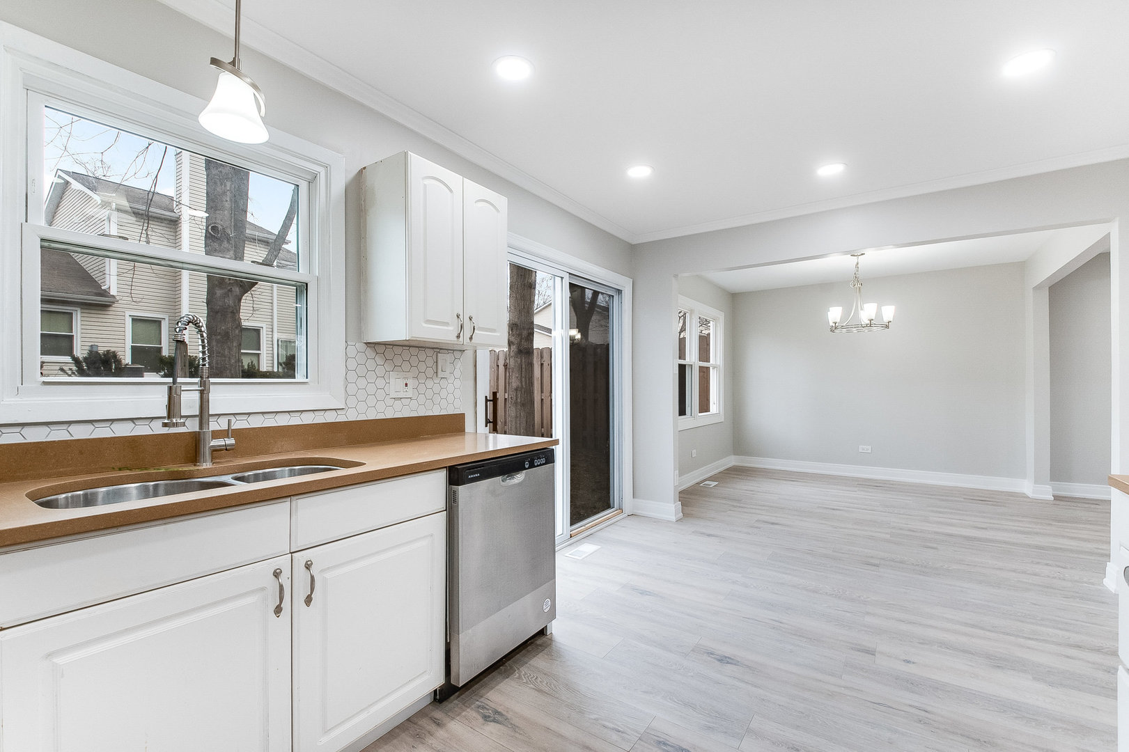 235 Hedgerow Drive Bloomingdale, IL 60108 - Photo 5 of 24 a kitchen with a sink and refrigerator