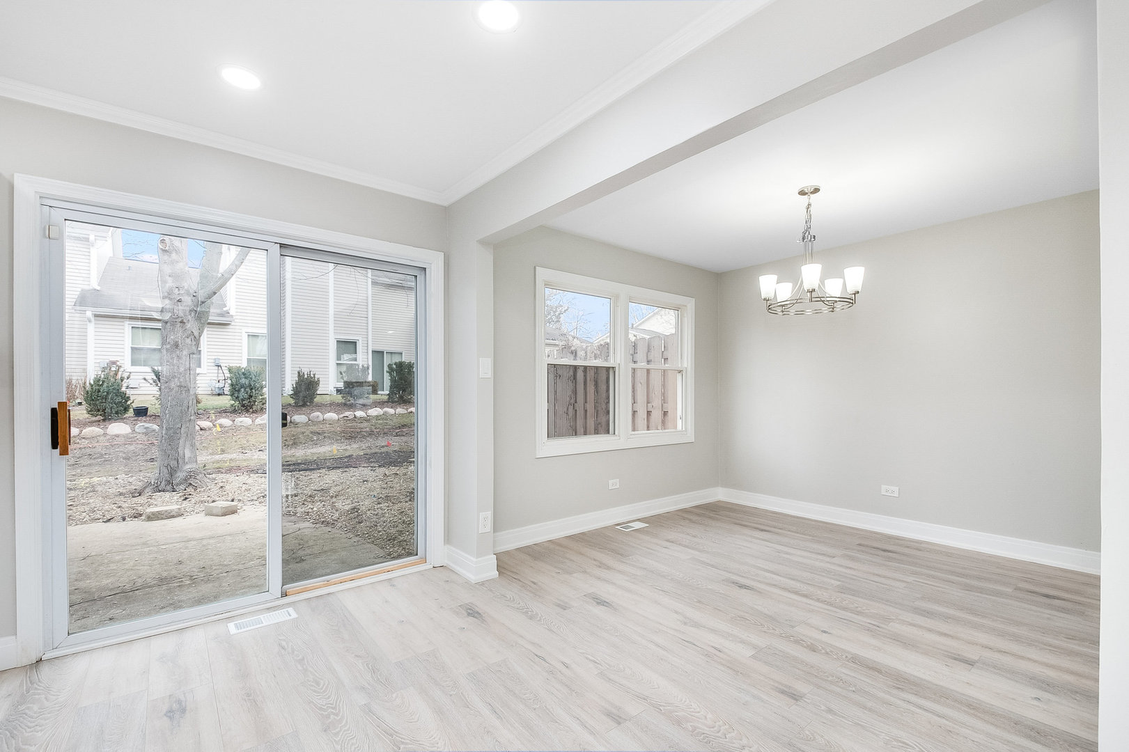 235 Hedgerow Drive Bloomingdale, IL 60108 - Photo 6 of 24 an empty room with wooden floor and windows