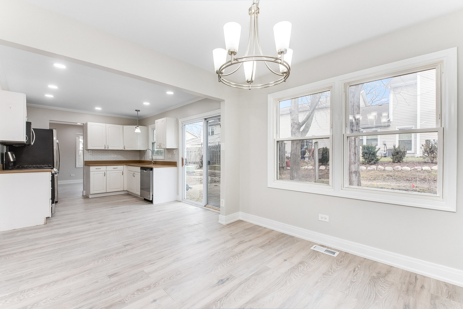 235 Hedgerow Drive Bloomingdale, IL 60108 - Photo 7 of 24 a view of a kitchen with a sink wooden floor and a refrigerator