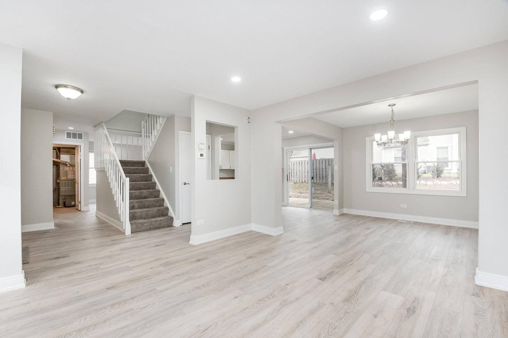 235 Hedgerow Drive Bloomingdale, IL 60108 - Photo 9 of 24 an empty room with wooden floor and staircase