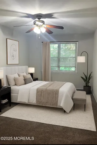 a bedroom with bed and a large window