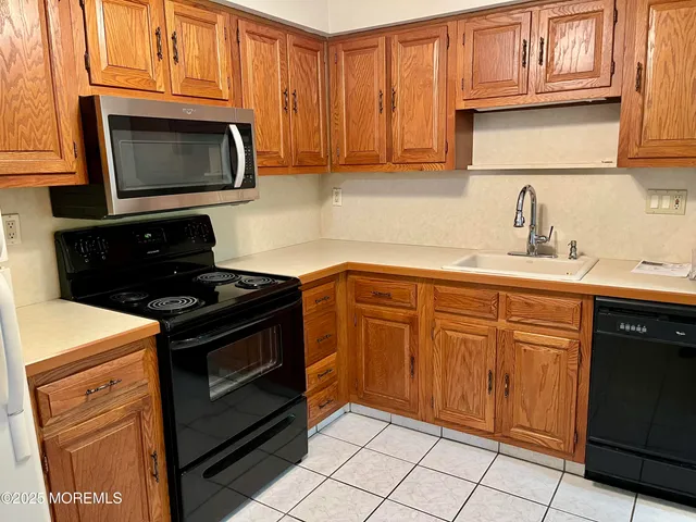 a kitchen with granite countertop cabinets and steel stainless steel appliances