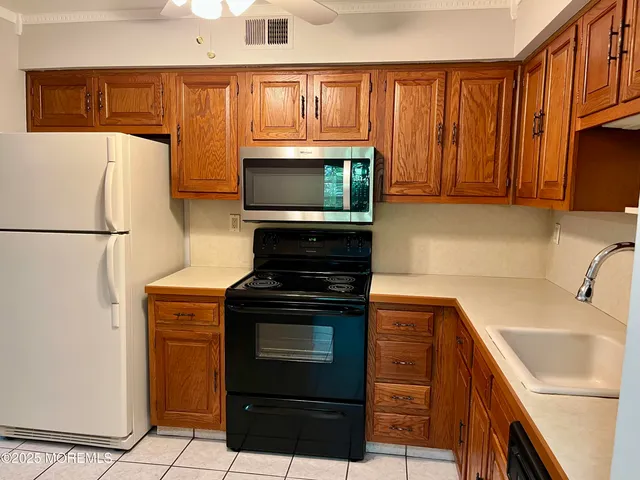a kitchen with a refrigerator stove and microwave