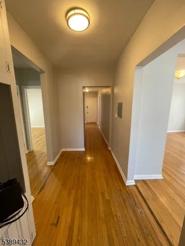 a view of a room with wooden floor and staircase