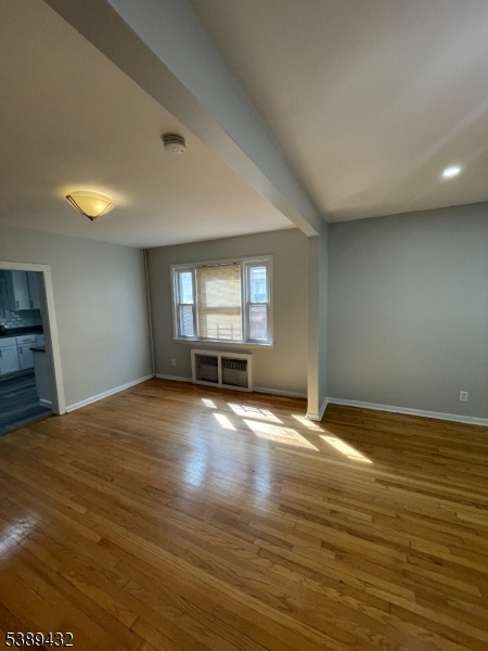 388 Leslie Street Newark, NJ 07112 - Photo 3 of 19 a view of empty room with wooden floor and fan
