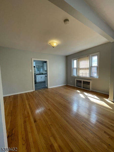 388 Leslie Street Newark, NJ 07112 - Photo 4 of 19 an empty room with a empty space and windows