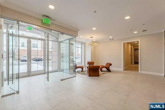 a lobby with furniture and large windows