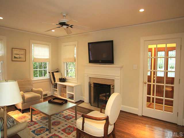16 Henderson Street Raleigh, NC 27607 - Photo 2 of 12 a living room with furniture a fireplace and a flat screen tv