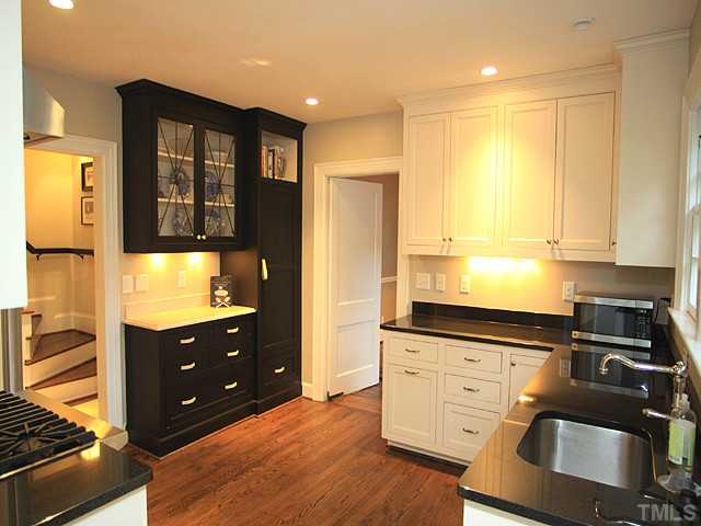 16 Henderson Street Raleigh, NC 27607 - Photo 5 of 12 a kitchen with granite countertop a refrigerator and a stove top oven
