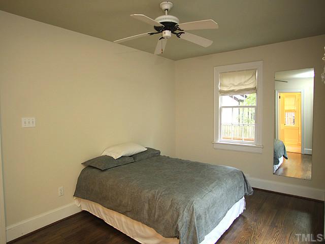 16 Henderson Street Raleigh, NC 27607 - Photo 7 of 12 a bedroom with a bed and wooden floor