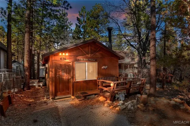 a backyard of a house with table and chairs