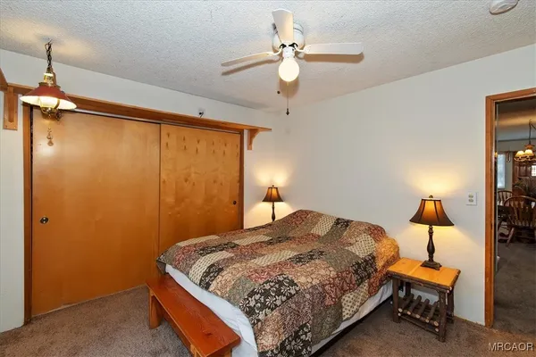 a bedroom with a bed a lamp and a chandelier