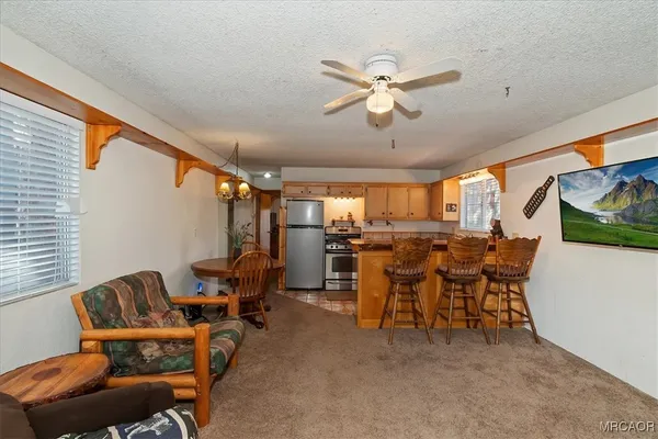 a view of a livingroom with furniture and a window
