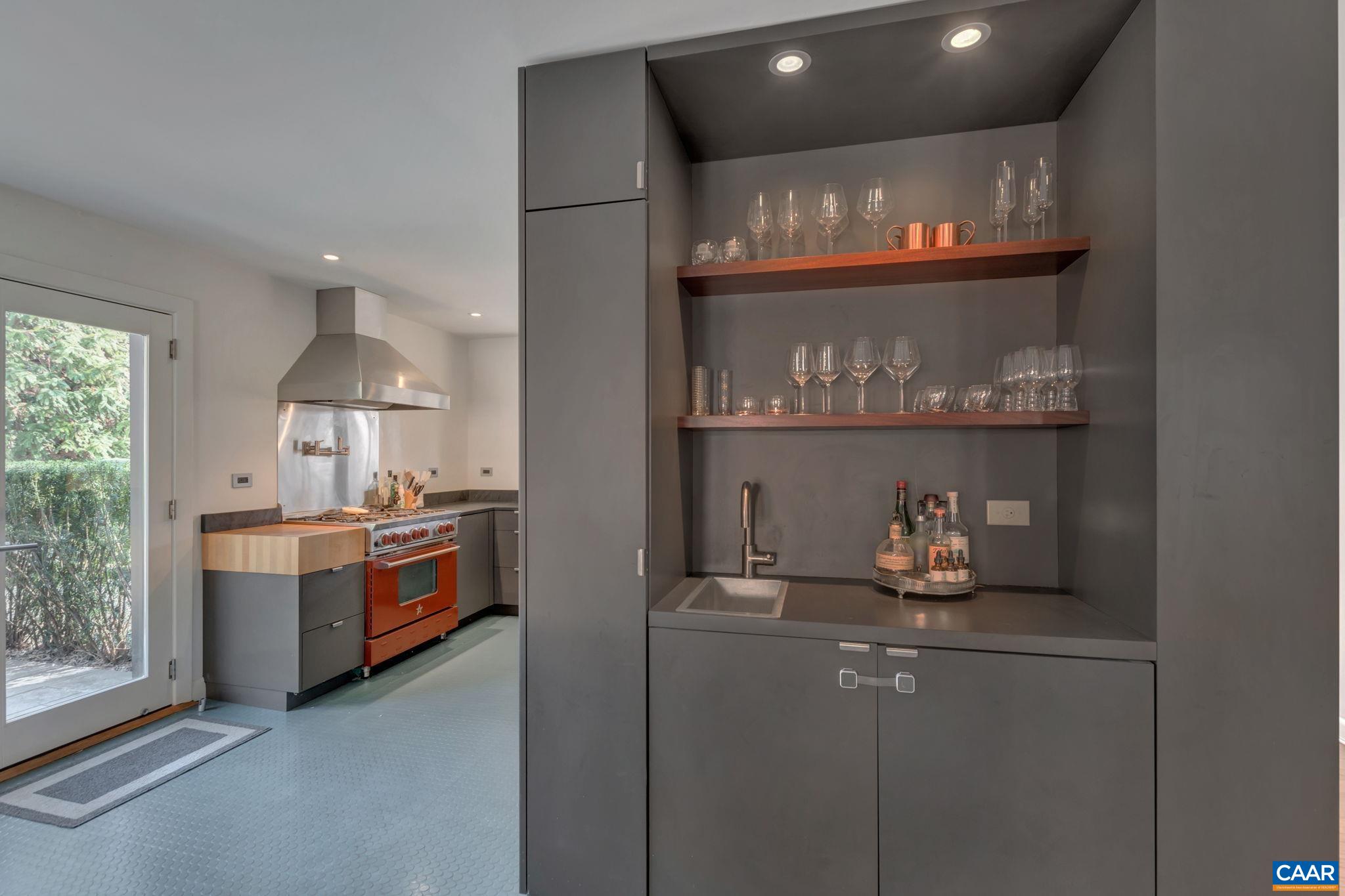 1717 Meadowbrook Heights Road Charlottesville, VA 22901 - Photo 14 of 43 a room with a fireplace and cabinets