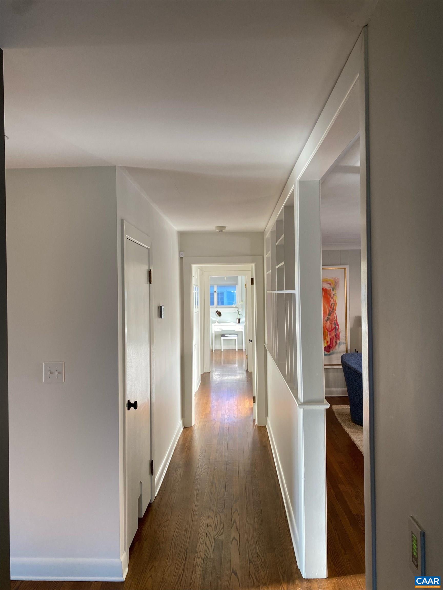 1717 Meadowbrook Heights Road Charlottesville, VA 22901 - Photo 23 of 43 a view of a hallway with wooden floor and livingroom