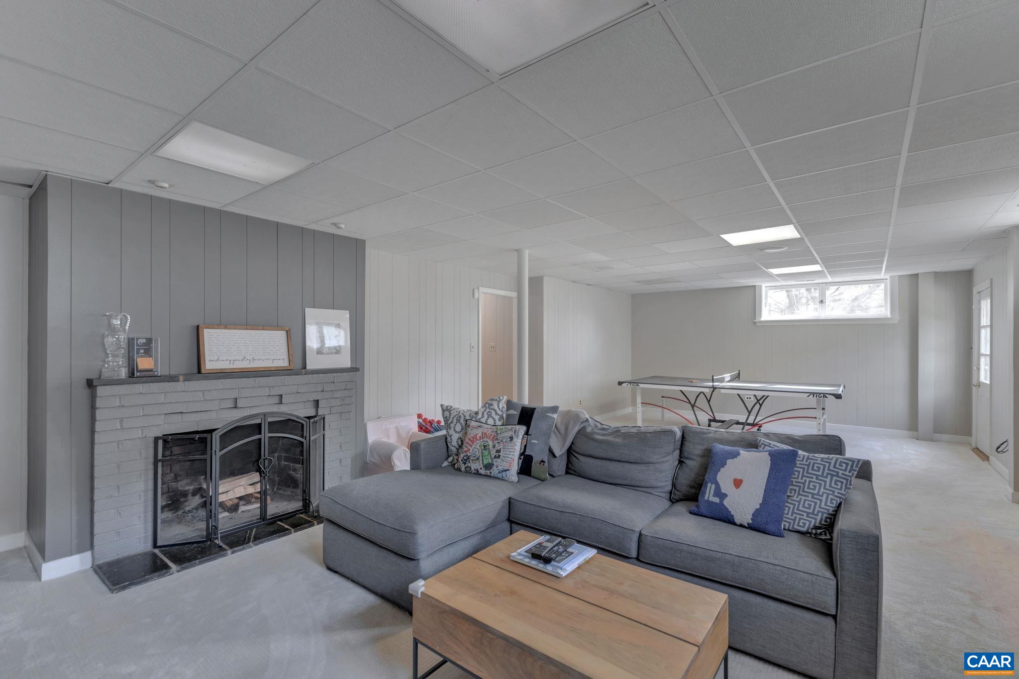 1717 Meadowbrook Heights Road Charlottesville, VA 22901 - Photo 24 of 43 a living room with furniture and a fireplace