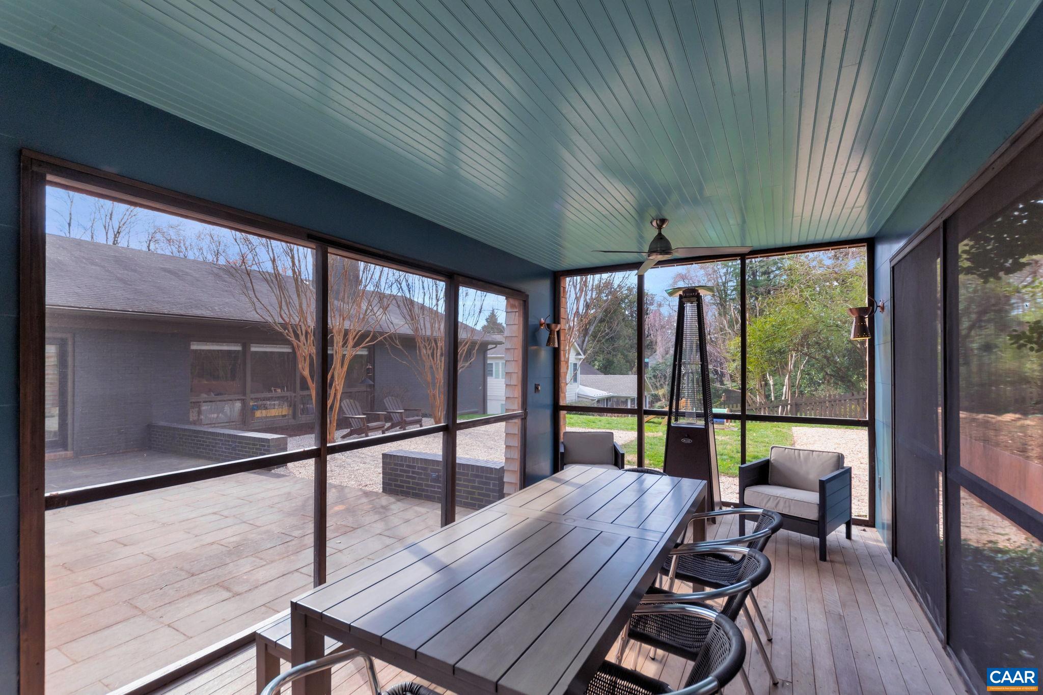 1717 Meadowbrook Heights Road Charlottesville, VA 22901 - Photo 34 of 43 a view of a patio with a table chairs and wooden floor