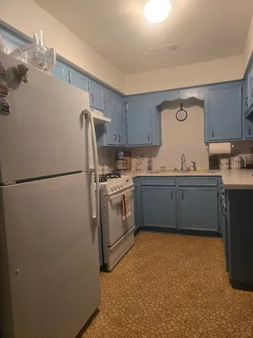 a utility room with cabinets washer and dryer