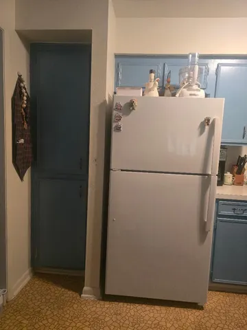 a white refrigerator freezer sitting in a kitchen
