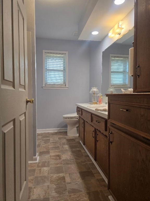 1930 5th Street Hempstead, TX 77445 - Photo 15 of 24 a bathroom with a sink a toilet and mirror