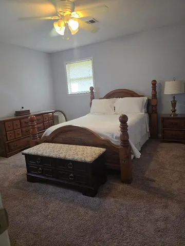 a bedroom with a bed and window