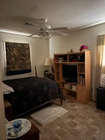 a bedroom with a bed and a television in it