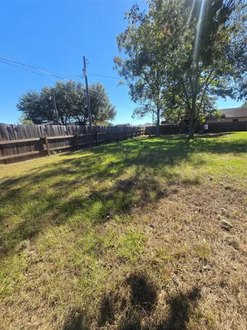 a view of yard with swimming pool and green space
