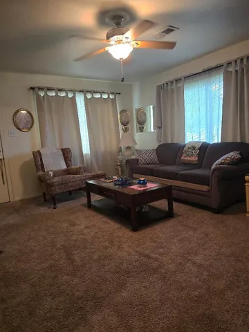 a living room with furniture and a large window