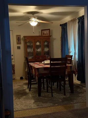 a dining room with furniture and window