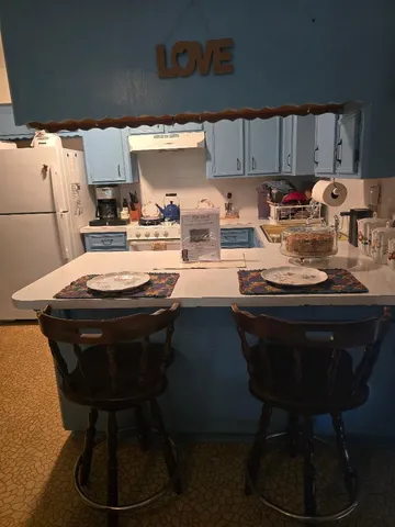 a kitchen with a sink appliances and cabinets