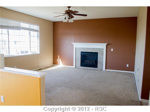 12243 St Annes Road Peyton, CO 80831 - Photo 5 of 15 Large Living Room with Gas Fireplace