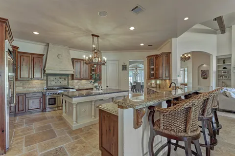a living room with furniture a fireplace and a floor to ceiling window