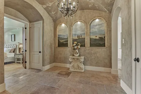 a living room with a bed furniture and fireplace