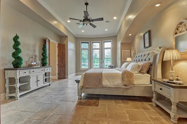 a bedroom with a bed and a chandelier