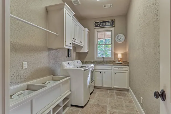 a spacious bathroom with a granite countertop sink toilet and shower