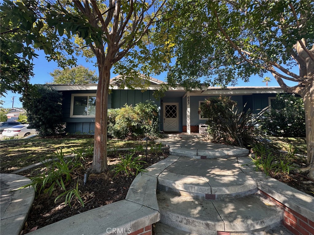 a view of a house with yard and a garden