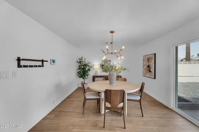 a view of a dining room with furniture and chandelier