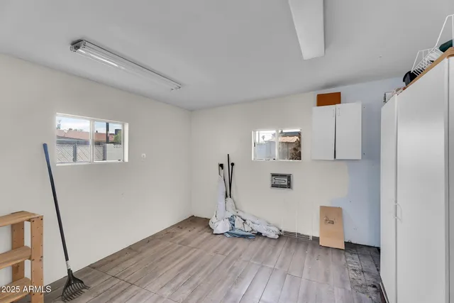 a view of empty room with wooden floor