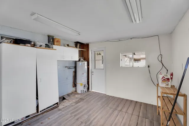a view of a storage & utility room with closet fridge