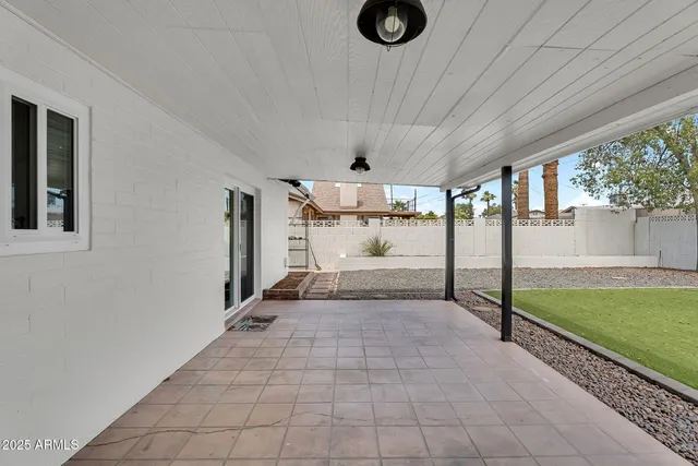 a view of a big room with floor to ceiling windows and an outdoor view