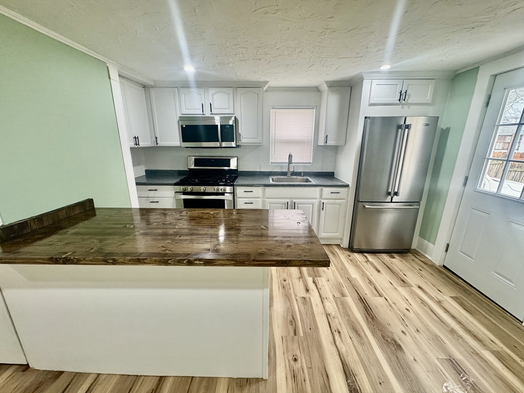 2 Wall Court Maynard, MA 01754 - Photo 3 of 11 a kitchen with granite countertop a refrigerator and a sink