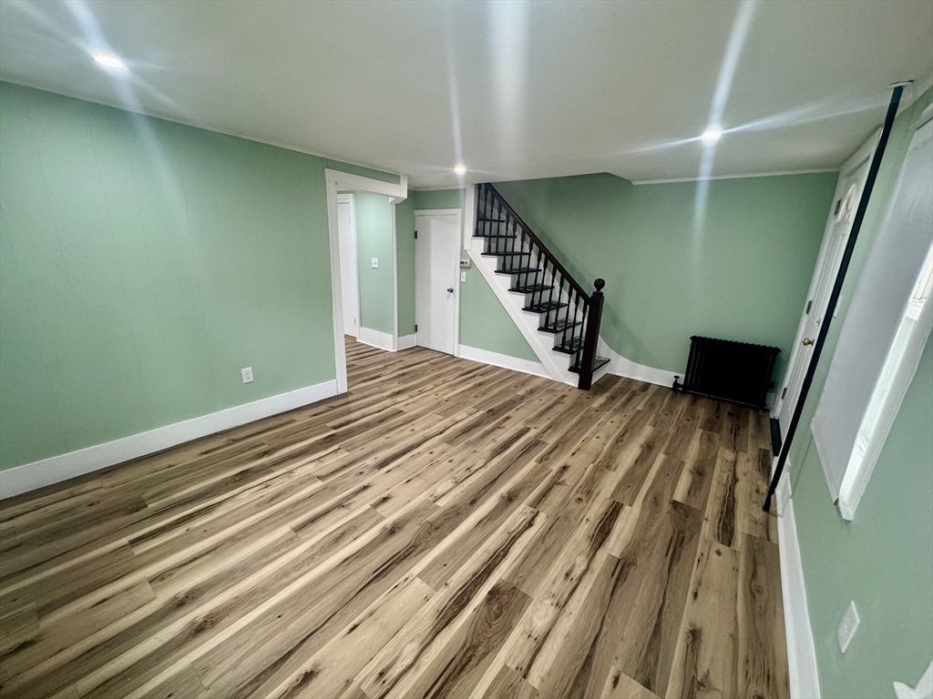 2 Wall Court Maynard, MA 01754 - Photo 4 of 11 a view of a livingroom with wooden floor and stairs