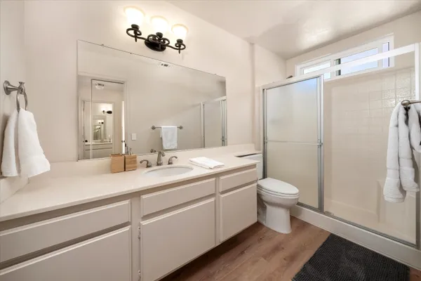 a bathroom with a double vanity sink toilet and shower